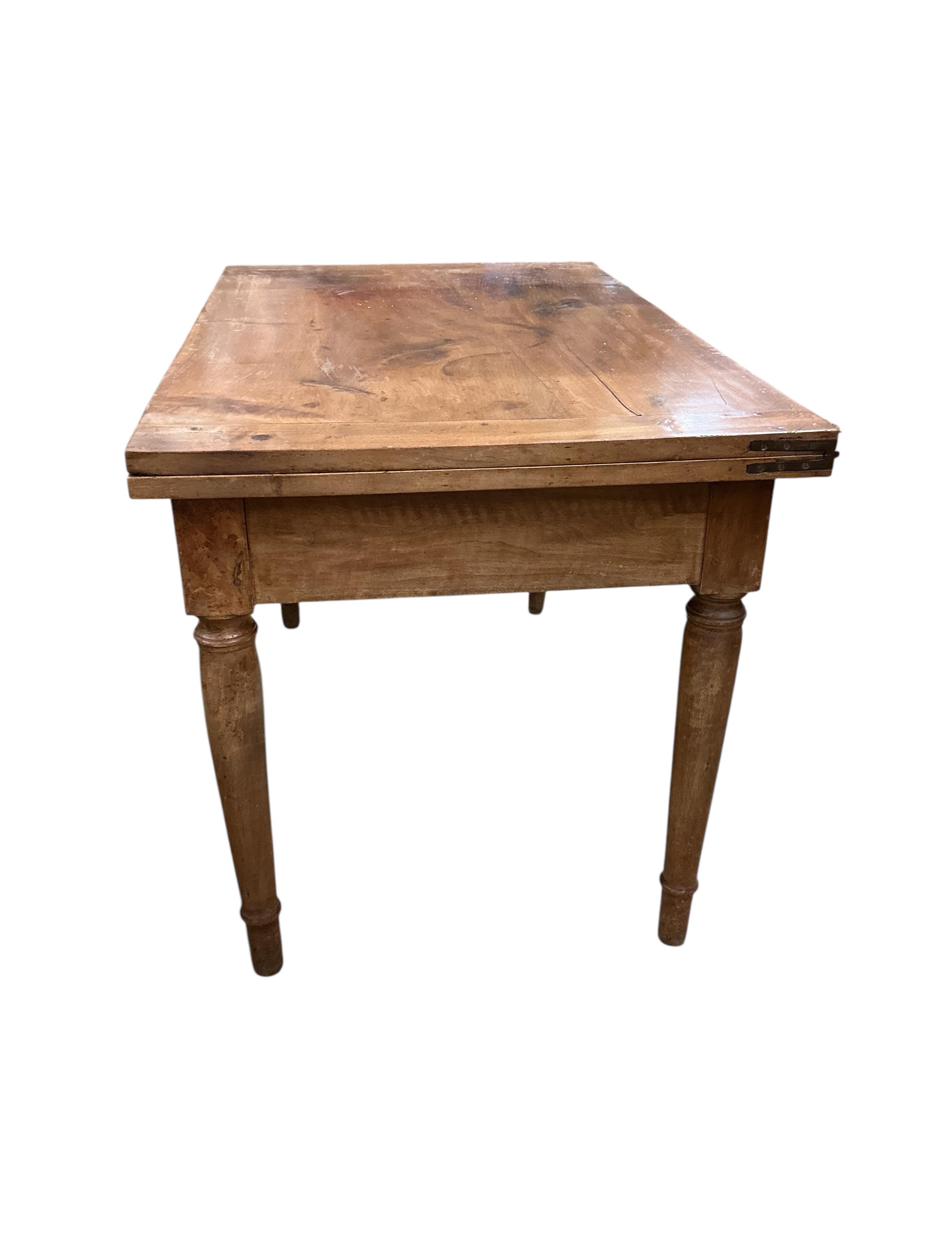 A 19th century French folding fruitwood kitchen table, width 117cm, depth 72cm, height 74cm